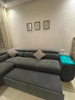 a living room with a gray couch with pillows at Luxury 3 Bedroom Apt Near Park and Sea, Heated Indoor Pool, Wifi, Free Parking in Casablanca