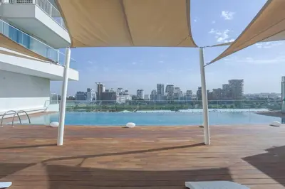 a view of a pool from a building with an umbrella at Résidence Luxuria - Rooftop Pool in Casablanca