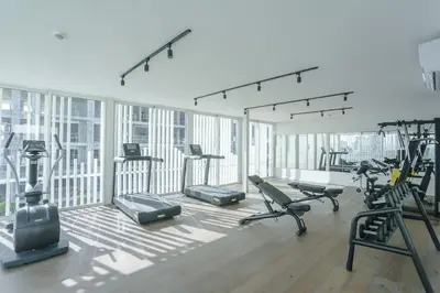 a gym with several treadmills and cardio machines at Résidence Luxuria - Rooftop Pool in Casablanca