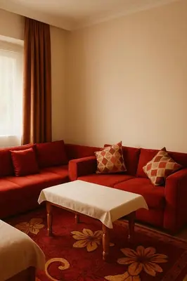 a living room with a red couch and a table at Dar wifak in Temara