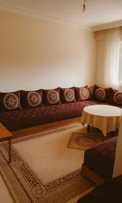 a living room with a couch and a table at Dar wifak in Temara