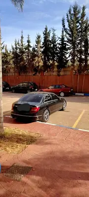 a black car parked in a parking lot at Dar wifak in Temara