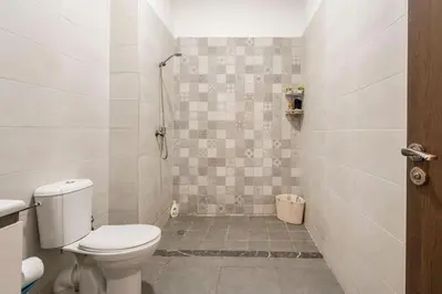 a small bathroom with a toilet and a shower at New appartement next to the beach Sidi Rahal in Sidi Rahal