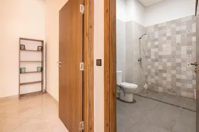 a bathroom with a toilet and a shower at New appartement next to the beach Sidi Rahal in Sidi Rahal