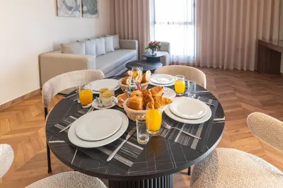 a black table with food and drinks on it in a living room at Citadines Almaz Aparthotel Casablanca in Casablanca