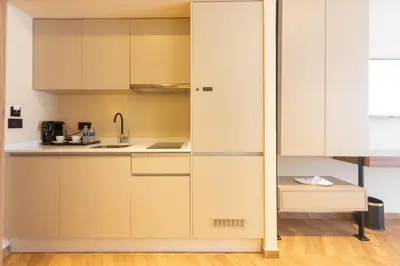 a kitchen with white cabinets and a sink at Citadines Almaz Aparthotel Casablanca in Casablanca