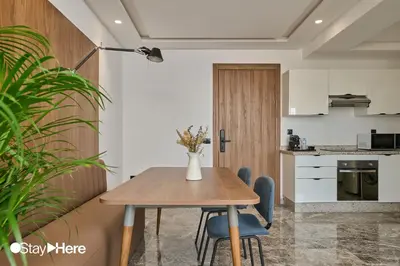 a kitchen and dining room with a wooden table and chairs at StayHere Casablanca - Oasis - Premium Residence in Casablanca