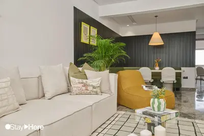 a living room with a white couch and a yellow chair at StayHere Casablanca - Oasis - Premium Residence in Casablanca