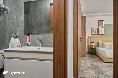 a bathroom with a sink and a bed at StayHere Casablanca - Oasis - Premium Residence in Casablanca