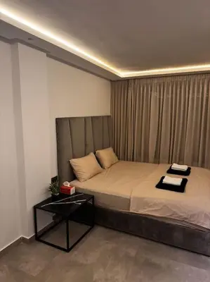a bedroom with a bed and a table in it at Sunset Lover in Casablanca-Port