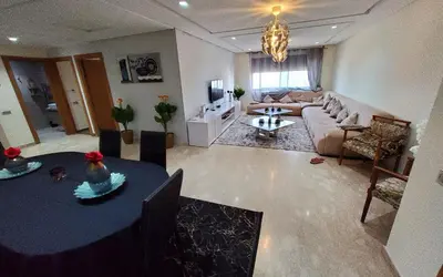 a living room with a couch and a table at Appart chic vue Mer in Casablanca
