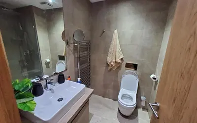 a bathroom with a sink and a toilet and a mirror at Appart chic vue Mer in Casablanca