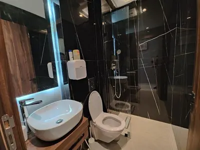 a bathroom with a toilet and a sink and a shower at Studio Palmiers Maarif in Casablanca