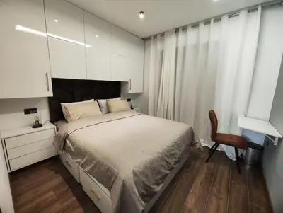 a bedroom with a bed and a desk and a chair at Studio Palmiers Maarif in Casablanca