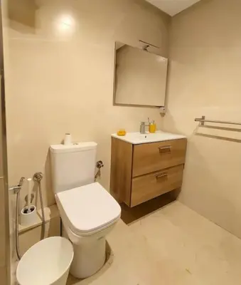 a bathroom with a white toilet and a sink at شقة فاخرة ومريحة في قلب الرباط in Rabat