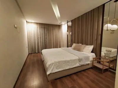 a bedroom with a large bed and a table at شقة فاخرة ومريحة في قلب الرباط in Rabat