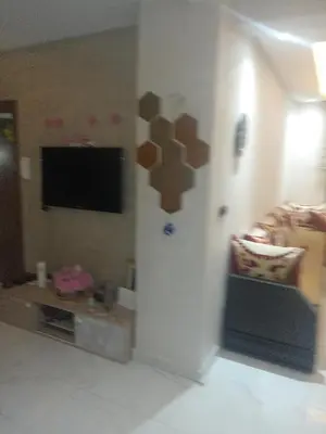 a living room with a couch and a flat screen tv at Basatin al firdaws in Ben Yakhlef