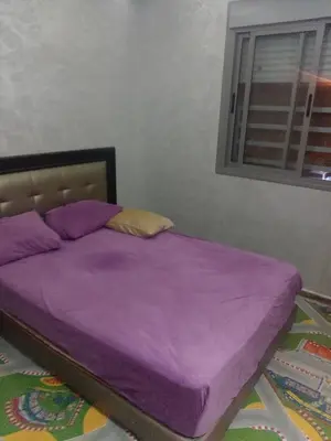 a purple bed in a bedroom with a window at Basatin al firdaws in Ben Yakhlef