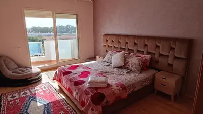 a bedroom with a bed with a large window at Suite Meublée à Nouaceur in Nouaceur