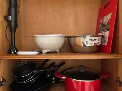 a shelf with cooking utensils and a mortar and pestle at Appartement moderne 2 chambres avec parking Agdal in Rabat