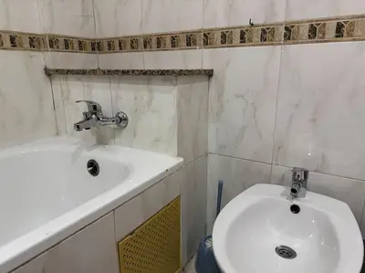 a bathroom with a sink and a white toilet at Appartement moderne 2 chambres avec parking Agdal in Rabat