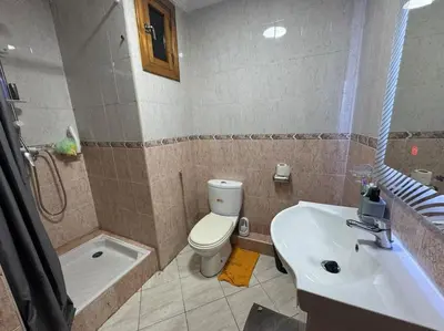 a bathroom with a toilet and a tub and a sink at Appartement moderne avec parking - Proche Mall in Rabat