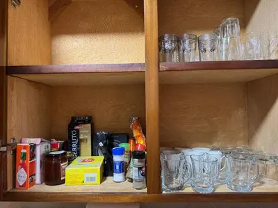 a shelf with glasses and other items on it at Appartement moderne avec parking - Proche Mall in Rabat