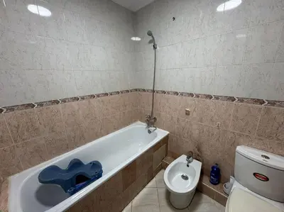 a bathroom with a toilet and a bath tub and a toilet at Appartement moderne avec parking - Proche Mall in Rabat