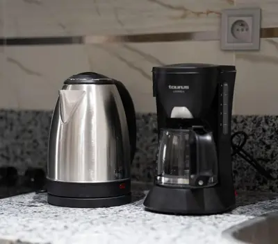 a coffee maker sitting on a counter next to a coffee pot at Séjour Élégant et Détente au Bord de la Piscine in Aïn Harrouda