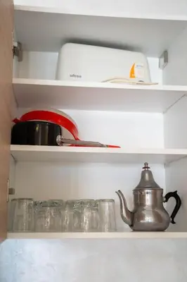 a tea kettle on a shelf in a refrigerator at Cosy appartement 2 BR avec vue panoramique piscine in Aïn Harrouda