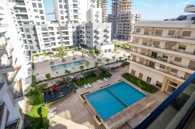 an overhead view of two swimming pools in a city at Cosy appartement 2 BR avec vue panoramique piscine in Aïn Harrouda