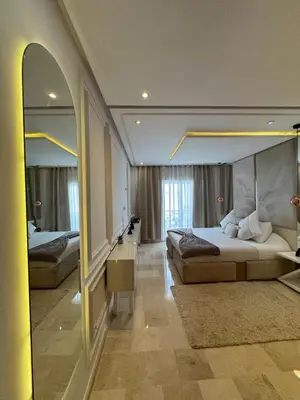 a bedroom with a large bed and a mirror at 3 Bedroom apartment near Highway with parking in Casablanca