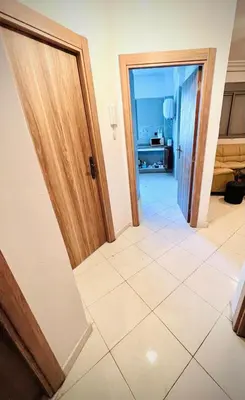 a hallway with an open door and a tile floor at appartement neuf top quartier bouskoura a 2 min de l'Hôpital Universitaire International Mohammed 6 in Casablanca