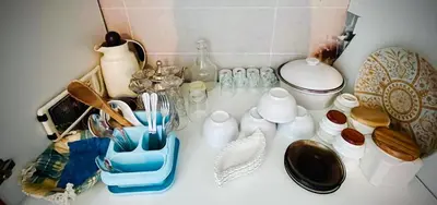 a counter top with dishes and other items on it at appartement neuf top quartier bouskoura a 2 min de l'Hôpital Universitaire International Mohammed 6 in Casablanca