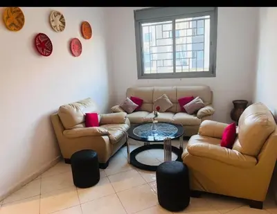 a living room with two couches and a table at appartement neuf top quartier bouskoura a 2 min de l'Hôpital Universitaire International Mohammed 6 in Casablanca