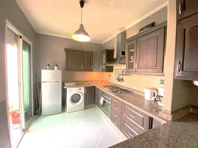 a kitchen with a white refrigerator and a dishwasher at Cosy calm 2BDR central near train & tramway in Casablanca