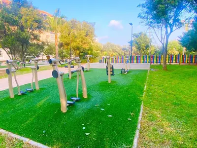 a park with a bunch of playground equipment in the grass at Cosy calm 2BDR central near train & tramway in Casablanca