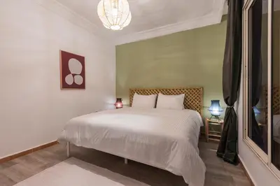 a bedroom with a white bed and a window at Stylish APPT 2 BDR Downtown of Rabat by MERAT HOME in Rabat