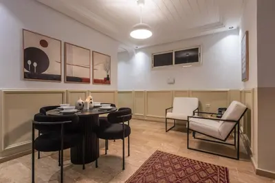 a waiting room with a table and chairs at Stylish APPT 2 BDR Downtown of Rabat by MERAT HOME in Rabat