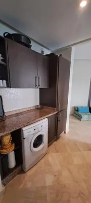 a kitchen with a washing machine and a counter at Appartement Beach House 2 Dar Bouazza in Dar Bouazza