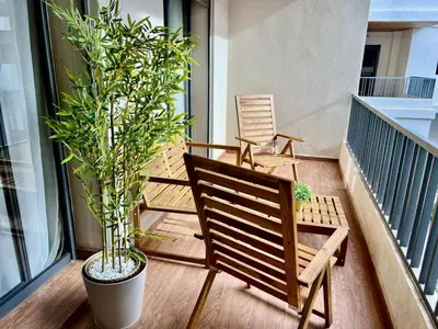 a balcony with a bench and a potted plant at M océan in Mohammedia