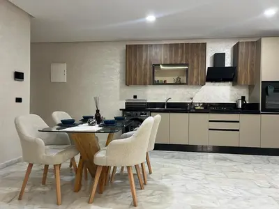 a kitchen with a table and chairs in a room at M océan in Mohammedia