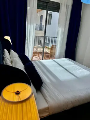a bedroom with a bed with a view of a balcony at M océan in Mohammedia