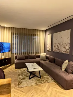 a living room with a couch and a coffee table at Studio chaleureux 50m2 avec cuisine au centre de casa et proche du tramway ghandi in Casablanca