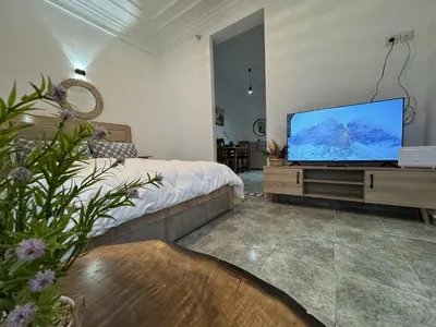 a living room with a flat screen tv on a dresser at appartement pour les familles , couples mariés bien meublé à Rabat in Rabat