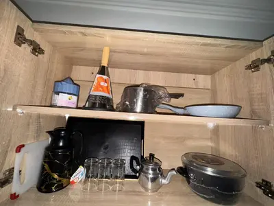 a kitchen counter with a microwave and some pots and pans at appartement pour les familles , couples mariés bien meublé à Rabat in Rabat