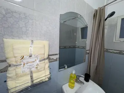 a bathroom with a sink and a mirror and a towel at appartement pour les familles , couples mariés bien meublé à Rabat in Rabat