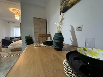 a living room with a wooden table with a bowl on it at appartement pour les familles , couples mariés bien meublé à Rabat in Rabat