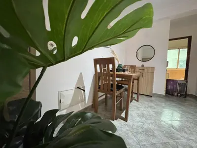 a dining room with a table and a plant at appartement pour les familles , couples mariés bien meublé à Rabat in Rabat