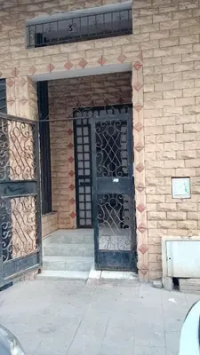 an entrance to a brick building with a black door at appartement pour les familles , couples mariés bien meublé à Rabat in Rabat